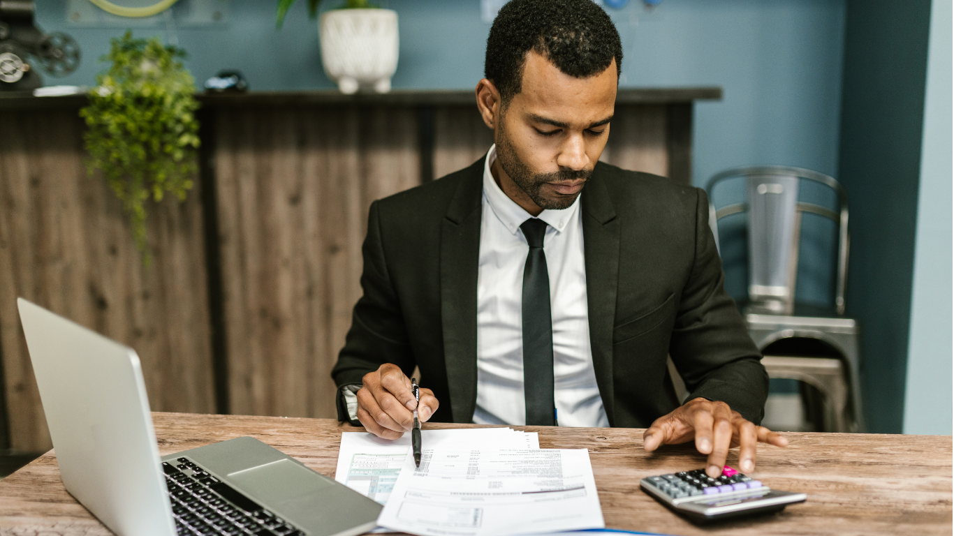 Financial professional reviewing reports and calculations